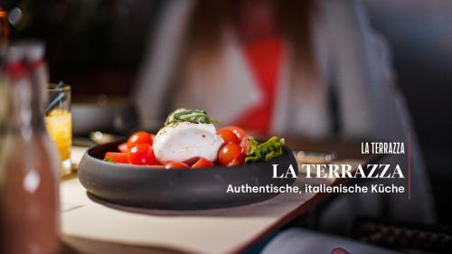 a plate of food with vegetables on a table at Hotel Stockalperhof in Brig