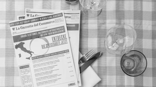 a table with a table cloth with a permit and a fork and knife at Hotel Stockalperhof in Brig