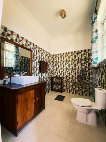 a bathroom with a sink and a toilet at Crystal Beach Nungwi in Nungwi