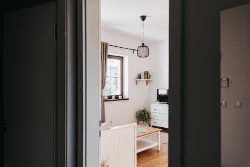 a hallway with a room with a desk and a window at Apartmán Efka in Deštné v Orlických horách