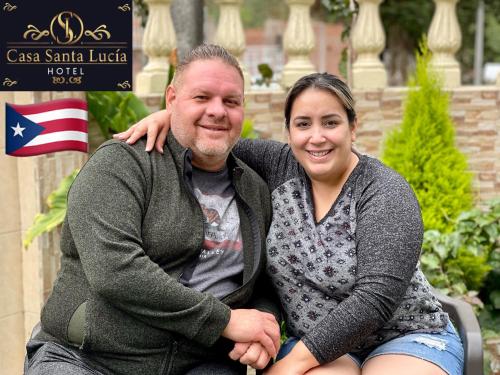 a man and a woman sitting next to each other at Hotel Casa Santa Lucía in Baños