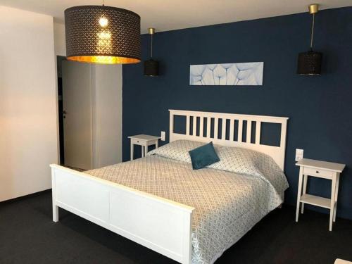 a bedroom with a white bed and a blue wall at Der Piestingerhof in Markt Piesting