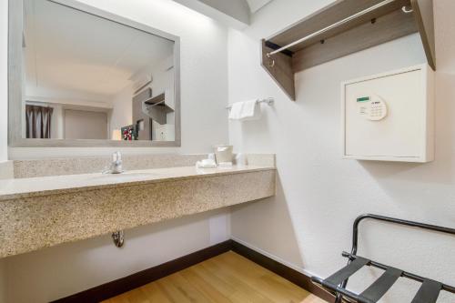 a bathroom with a sink and a mirror at Red Roof Inn Durham - Duke Univ Medical Center in Durham