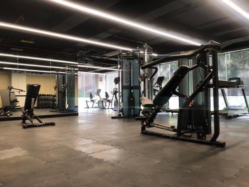 a gym with several tread machines in a room at Galeria Plaza San Jeronimo in Mexico City