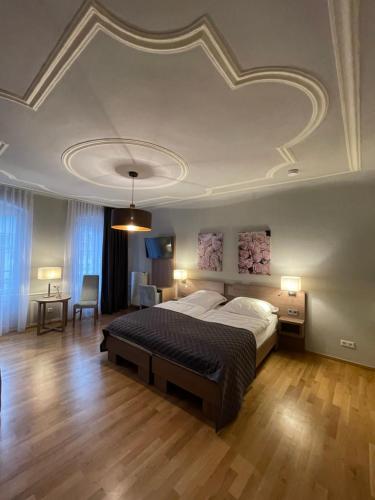 a bedroom with a large bed with a coffered ceiling at Boardinghouse Goethehaus in Heidelberg