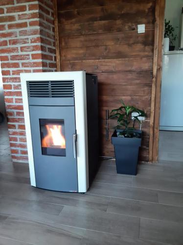 a fireplace with a fire in it sitting on a floor at Apartmani Lunija in Gornji Milanovac