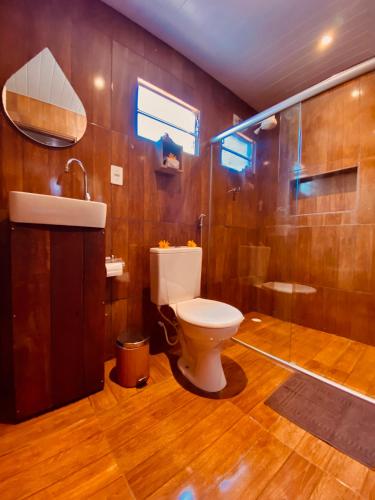 a bathroom with a toilet and a sink and a shower at Martinelli Residence in Fernando de Noronha