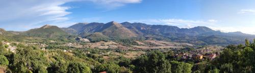 a view of a mountain valley with trees and houses at Tana Libera Tutti 1 Nature, Yourself, Love in Viggianello