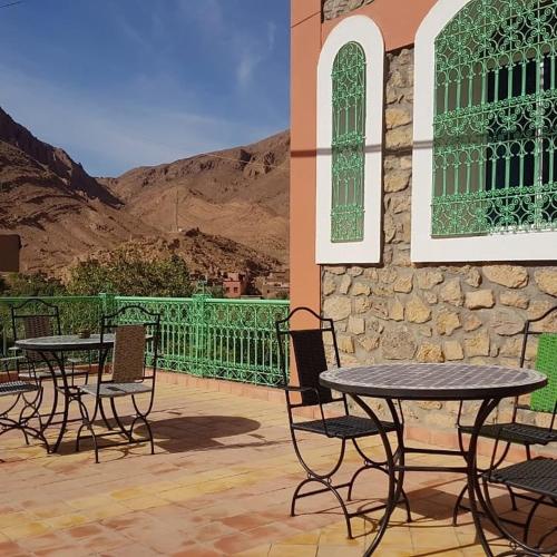 a group of tables and chairs on a patio at Auberge Restaurant Fatihi Freres in Tinerhir