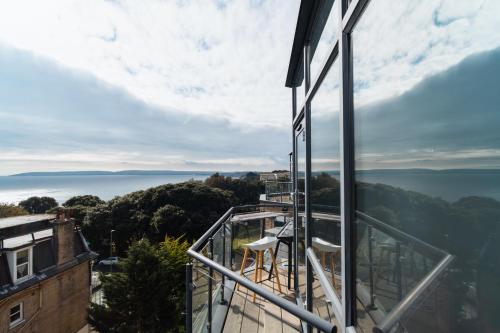 a view of the ocean from a balcony of a building at Westcliff Penthouse in Bournemouth