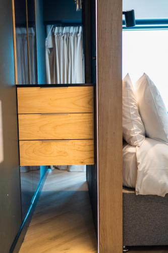 a closet with a wooden drawer and a mirror at Westcliff Penthouse in Bournemouth
