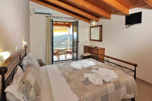 a bedroom with a bed with towels on it at Eleni Studios Parga in Parga