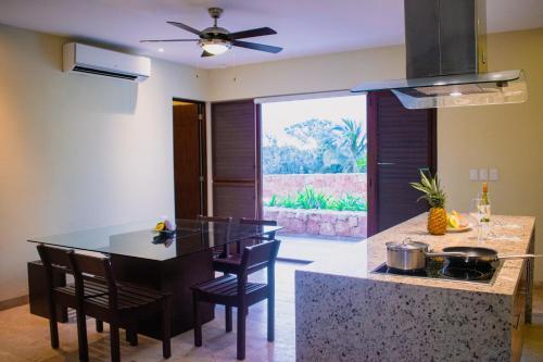 a kitchen with a table and chairs in a room at Villas Grand Marina Kinuh in Telchac Puerto