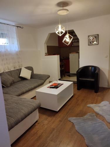 a living room with a couch and a table at V&J apartments in Podgorica