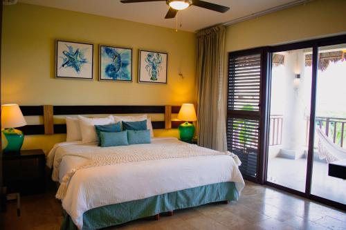 a bedroom with a large bed and a balcony at Villas Grand Marina Kinuh in Telchac Puerto