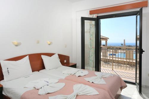 a bedroom with a bed with a view of the ocean at Eleni Studios Parga in Parga