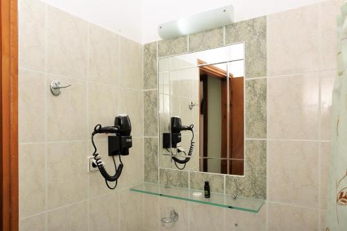 a bathroom with a shower with a mirror at Eleni Studios Parga in Parga