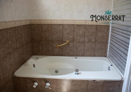 a bath tub in a tiled bathroom with a tub at Villas Montserrat Wellness Center in Guadalupe