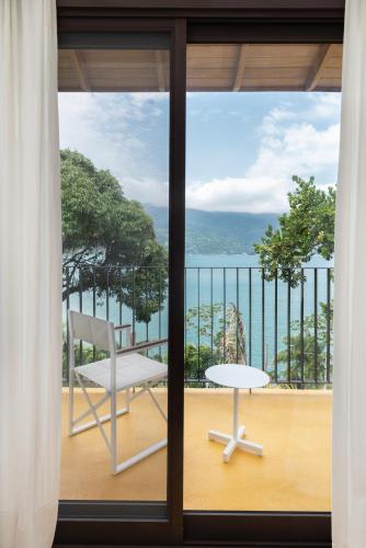 a view of a balcony with a chair and a table at Miradouro de São Sebastião in São Sebastião