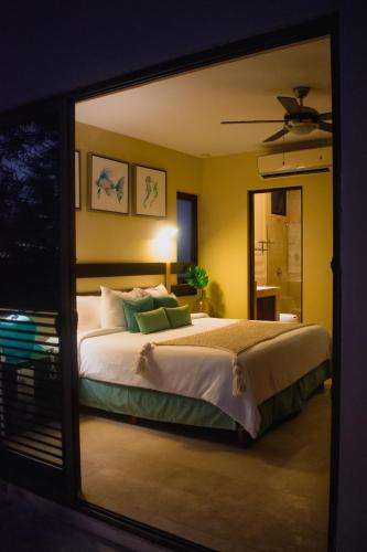 a bedroom with a large bed and a mirror at Villas Grand Marina Kinuh in Telchac Puerto