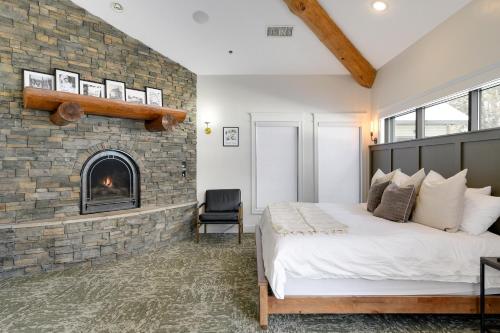 a bedroom with a brick fireplace and a bed at Balsam Lake Lodge in Balsam Lake