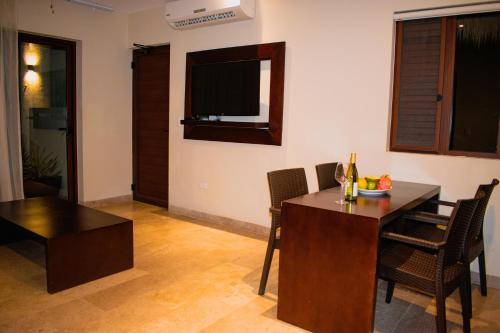 a dining room with a wooden table and chairs at Villas Grand Marina Kinuh in Telchac Puerto