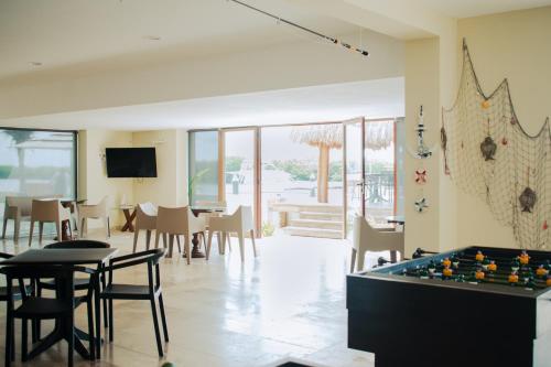 a living room with a pool table and chairs at Villas Grand Marina Kinuh in Telchac Puerto