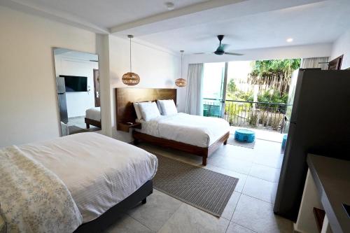 a hotel room with two beds and a balcony at Hotel Puerto Sayulita in Sayulita