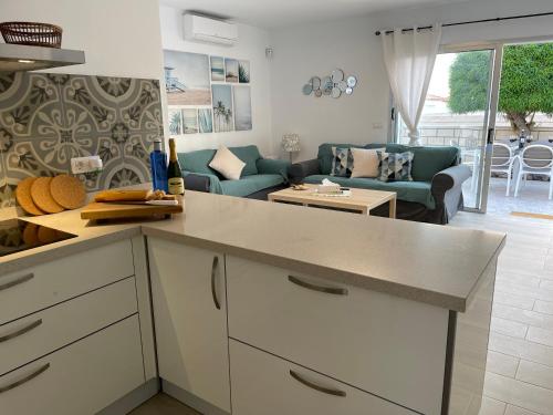 a kitchen and living room with a couch and a table at Villa Erna Relax Dream Holiday in Callao Salvaje