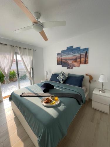 a bedroom with a bed with a plate of food on it at Villa Erna Relax Dream Holiday in Callao Salvaje