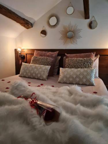 ein Schlafzimmer mit einem großen Bett mit einer weißen Decke in der Unterkunft Escapade Veyloise-Nuit romantique-Spa-Champagne in Pont-de-Veyle