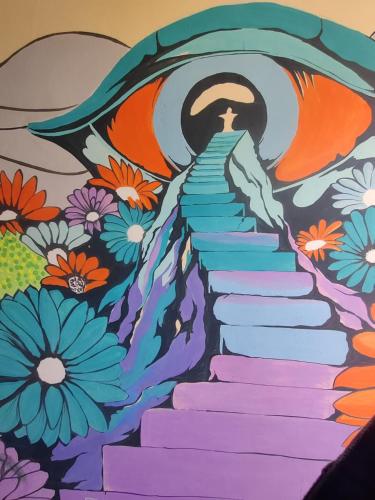 a mural of a stairway with a mural of flowers at Ikigai Manali in Nagar