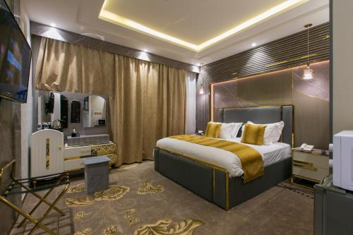 1 dormitorio con 1 cama grande y espejo en Lambert ApartHotel en Yeda
