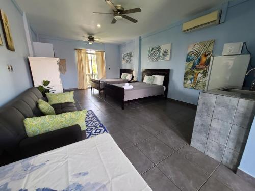 a living room with a couch and a table at Hermosa Beach House in Playa Hermosa