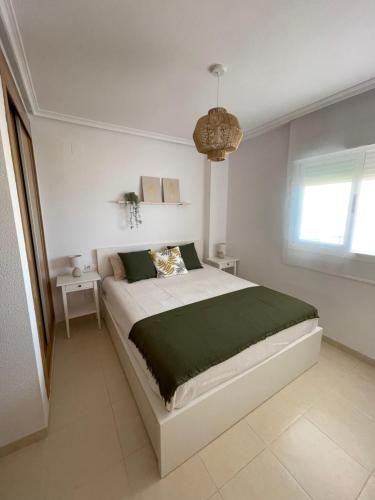 Un pat sau paturi într-o cameră la Apartamento MagicWorld
