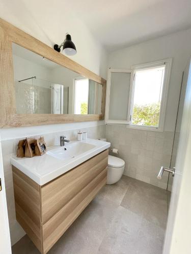 a bathroom with a sink and a toilet at BiniVento- Lovely villa with pool near the beach in Binibeca