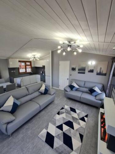 a living room with couches and a checkered floor at 4 Bed Luxury Lodge with Hot tub near Lake District in Warton