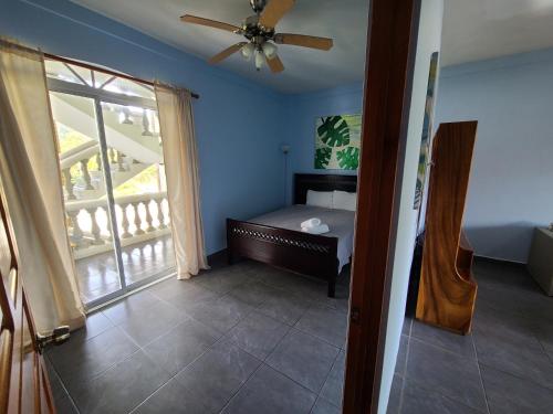 a bedroom with a bed and a ceiling fan at Hermosa Beach House in Playa Hermosa
