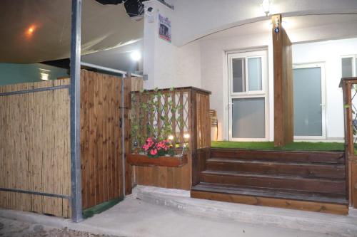 a house with a wooden fence and stairs and a window at צימר גבול החרמון in Majdal Shams