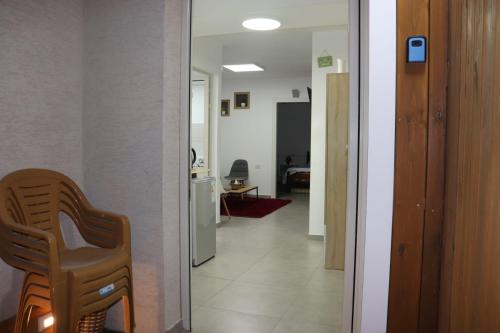 a view of a hallway with a chair and a kitchen at צימר גבול החרמון in Majdal Shams