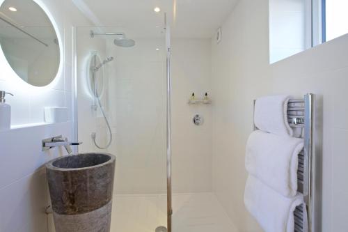 a bathroom with a shower and a sink at Pebbles King Studio in St Ives