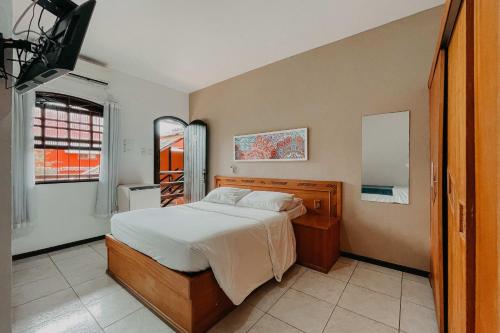 Säng eller sängar i ett rum på Búzios Centro Hotel