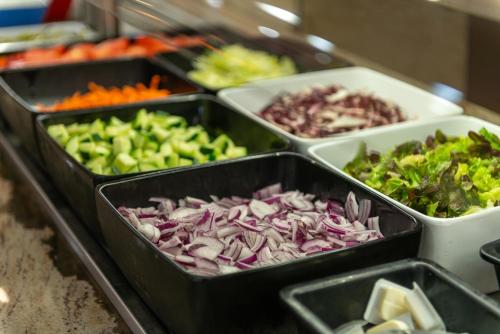 a group of trays of vegetables on a counter at O7 Nordeste Playa in Can Picafort