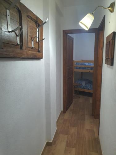 a hallway with a door and a room with a bed at ANTICA NEVIERA HOUSE in Castel di Sangro