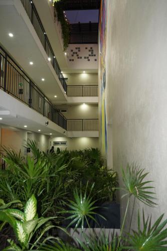 a lobby with plants in the middle of a building at Hotel Puerto Sayulita in Sayulita