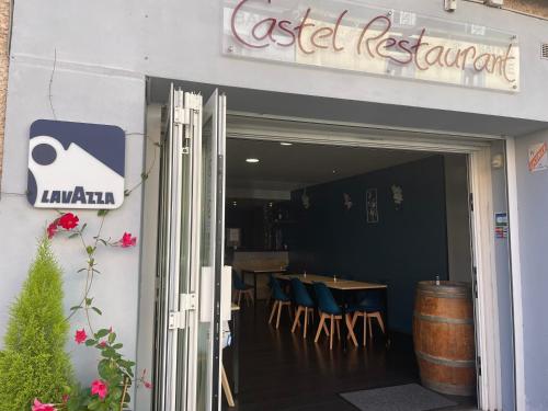 a restaurant with a table and chairs outside of it at Logis Hôtel Castel de Mirambel in Lourdes
