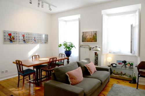 a living room with a couch and a table at My Apartment in Lisbon