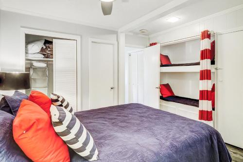 a bedroom with a bed and two bunk beds at Sea Side Villas 149 in Hilton Head Island