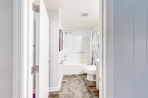 a white bathroom with a toilet and a shower at Sea Side Villas 149 in Hilton Head Island