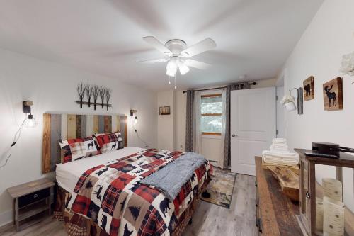 a bedroom with a bed and a ceiling fan at Magic Birch Lodge in Windham